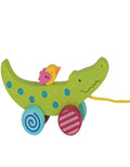 Colorful children's toy with a green dinosaur-like figure and a small pink chick on a white background