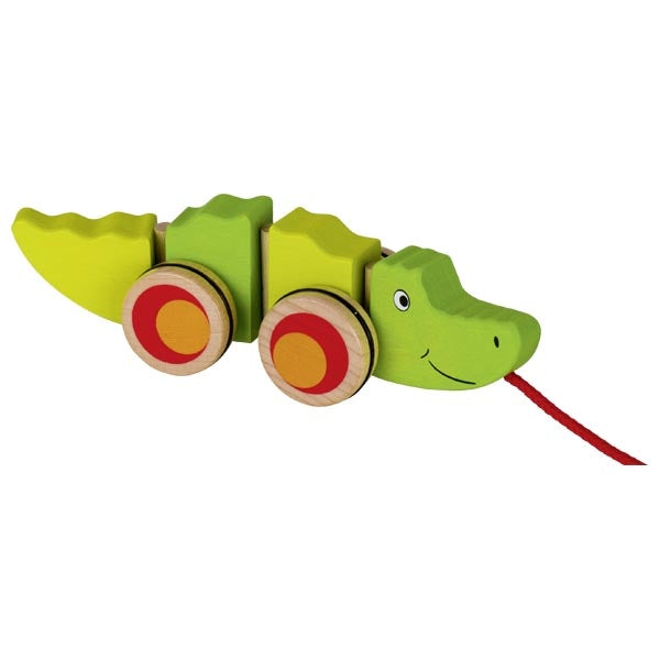 Green wooden toy crocodile with red and yellow wheels on a white background