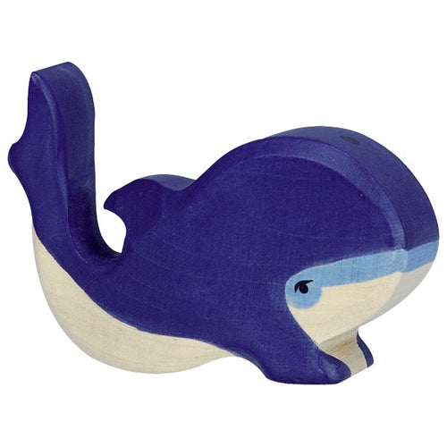 Wooden toy whale with blue and beige colors on a white background